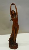 An Art Nouveau style wooden figure of a girl. 23 cm high.