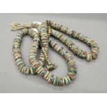 A Tibetan coral and turquoise set necklace. Approximately 97 cm long. each bead approximately 1.