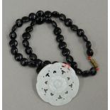A Chinese jade pendant on necklace. 5 cm diameter.