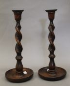 A pair of oak barley twist candlesticks. 31 cm high.