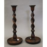 A pair of oak barley twist candlesticks. 31 cm high.