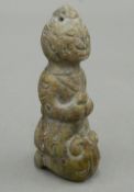 A Chinese hardstone carving of a kneeling figure. 7.5 cm high.