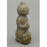 A Chinese hardstone carving of a kneeling figure. 7.5 cm high.