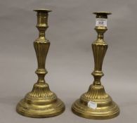 A pair of brass candlesticks. 27 cm high.