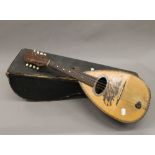 A cased mandolin. 61 cm long.