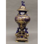 A large Victorian gilt decorated blue porcelain lidded vase. 51 cm high.
