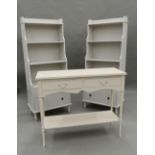 A pair of white painted bookcases and a side table. Bookcases 57.5 cm wide.
