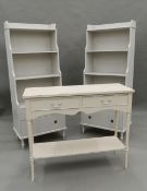 A pair of white painted bookcases and a side table. Bookcases 57.5 cm wide.