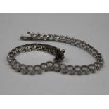 A 14 K white gold bracelet set with diamonds. 18.5 cm long (11 grammes total weight).