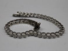 A 14 K white gold bracelet set with diamonds. 18.5 cm long (11 grammes total weight).