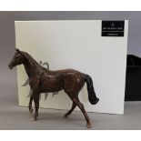 A boxed Royal Doulton figure of a thoroughbred horse. 22 cm wide.