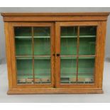 A Victorian glazed pine cabinet. 135 cm wide.