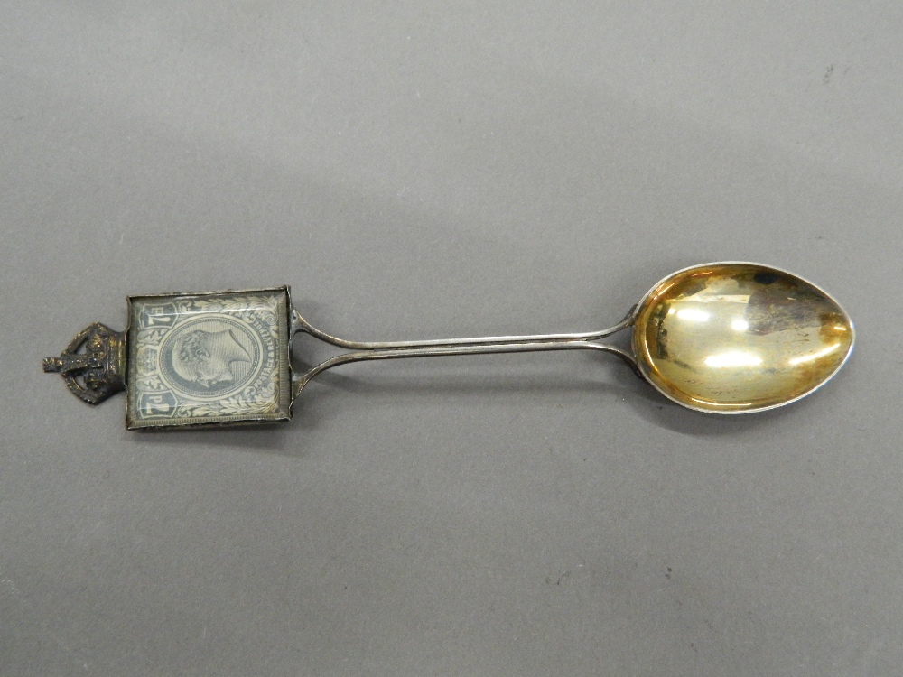 An Edward VII Coronation spoon inset with a stamp. 13 cm long (13 grammes total weight).