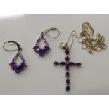 A pair of silver stone set earrings and a silver stone set cross on chain. The cross 3.5 cm high (9.