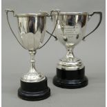 Two silver trophy cups, each on detachable base. Largest 19 cm high including stand (11.