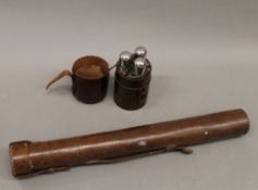 A case of leather flasks and a cylindrical leather case