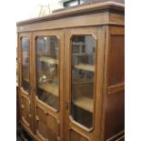 An early 20th century glazed oak bookcase cabinet. 168 cm wide.