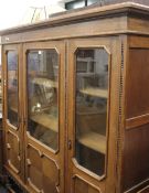 An early 20th century glazed oak bookcase cabinet. 168 cm wide.