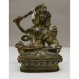 A small bronze figure of a seated deity. 8 cm high.