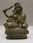 A small bronze figure of a seated deity. 8 cm high.