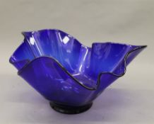 A large blue glass handkerchief vase. 39.5 cm wide.