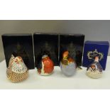 Four boxed Royal Crown Derby paperweights (all with stoppers), including a chicken and three birds.