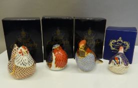 Four boxed Royal Crown Derby paperweights (all with stoppers), including a chicken and three birds.