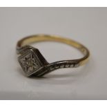 An 18 ct gold and diamond ring. Ring size K (1.