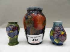 A small Moorcroft vase and two miniature Moorcroft vases. The former 8 cm high.