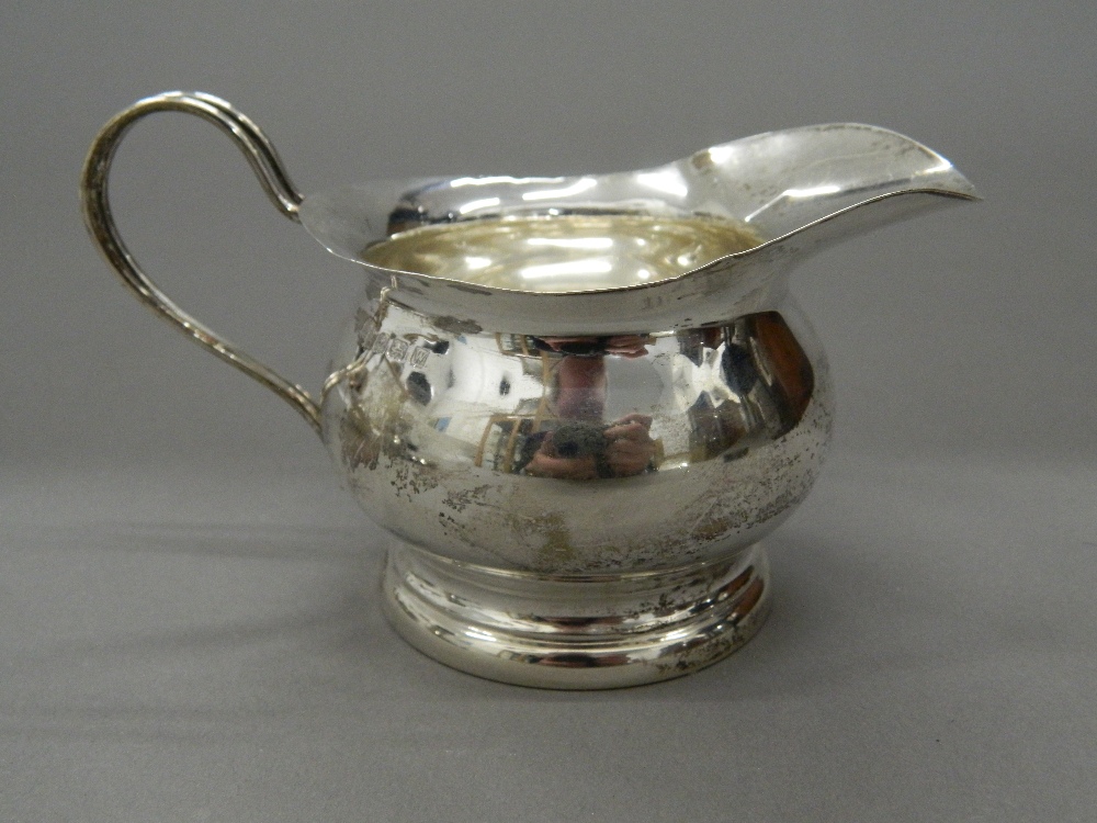 A silver cream jug, a mustard, a mug and spoons (7. - Image 2 of 9