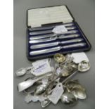 A cased set of silver handled knives together with a quantity of various silver spoons, tongs, etc.