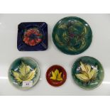 A quantity of Moorcroft dishes and an ash tray. The largest 15 cm diameter.