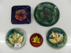 A quantity of Moorcroft dishes and an ash tray. The largest 15 cm diameter.