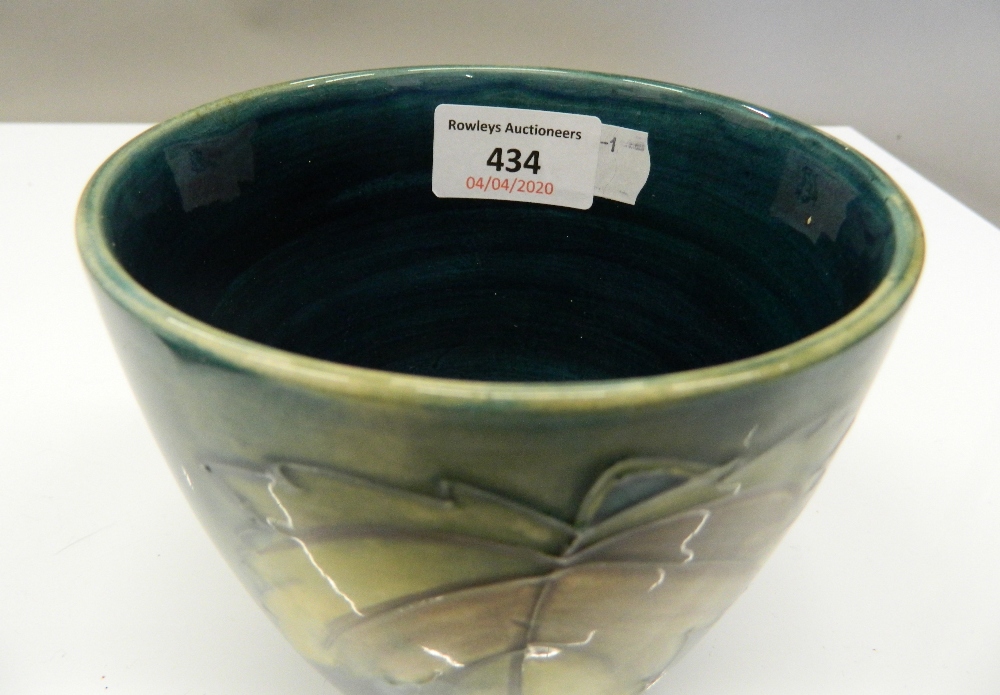 A green ground Moorcroft vase. 11.5 cm high. - Image 2 of 4