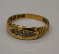 An 18 ct gold five stone diamond ring. Size N/O (3.1 grammes total weight).