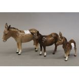 Three Beswick donkeys. The largest 13.5 cm high.