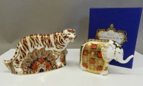 A boxed Royal Crown Derby elephant paperweight and an unboxed Bengal Tiger paperweight.