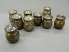 Nine miniature silver salts and peppers. Each approximately 3.5 cm high (99.