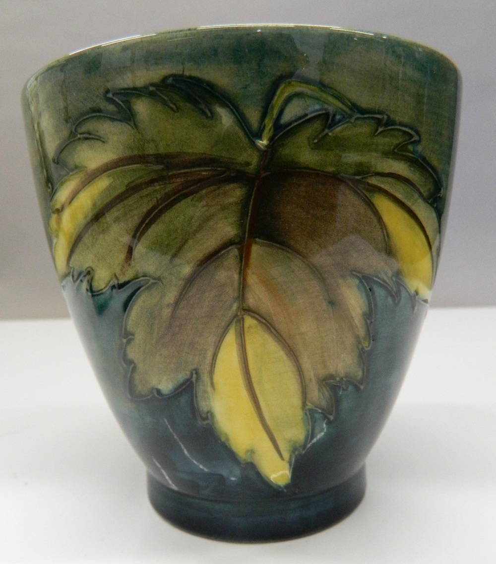 A green ground Moorcroft vase. 11.5 cm high. - Image 3 of 4