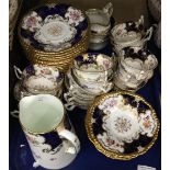 A gilt heightened florally decorated Coalport tea set