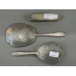 A silver three piece dressing set. Mirror 28.5 cm long.