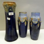 A pair of Royal Doulton vases and another. The latter 31 cm high.