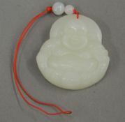 A Chinese Buddha pendant. 4.5 cm high.