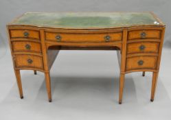 A 19th century satinwood sideboard, adapted to a desk. 132 cm wide.