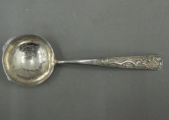 A Chinese silver spoon decorated with dragon and koi carp. 13.25 cm long (18 grammes).