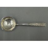 A Chinese silver spoon decorated with dragon and koi carp. 13.25 cm long (18 grammes).