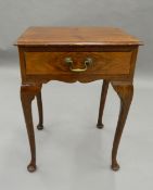 An early 20th century walnut side table. 45 cm wide.