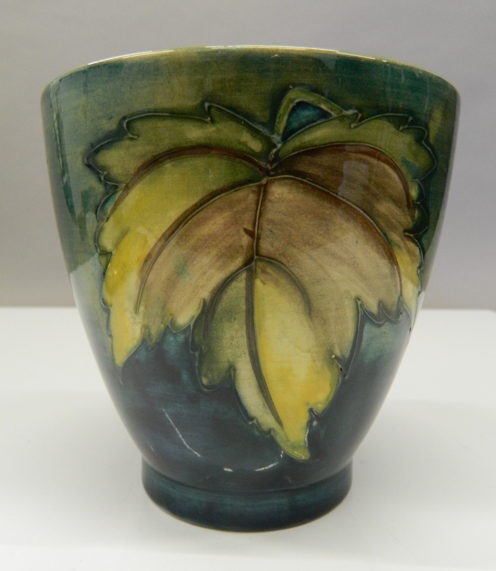 A green ground Moorcroft vase. 11.5 cm high.