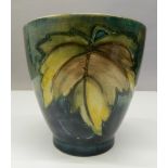 A green ground Moorcroft vase. 11.5 cm high.