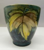 A green ground Moorcroft vase. 11.5 cm high.